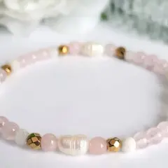Delikatna bransoletka z koralików kwarc różowy, pereł i złotych elementów. Symbol miłości i harmonii.